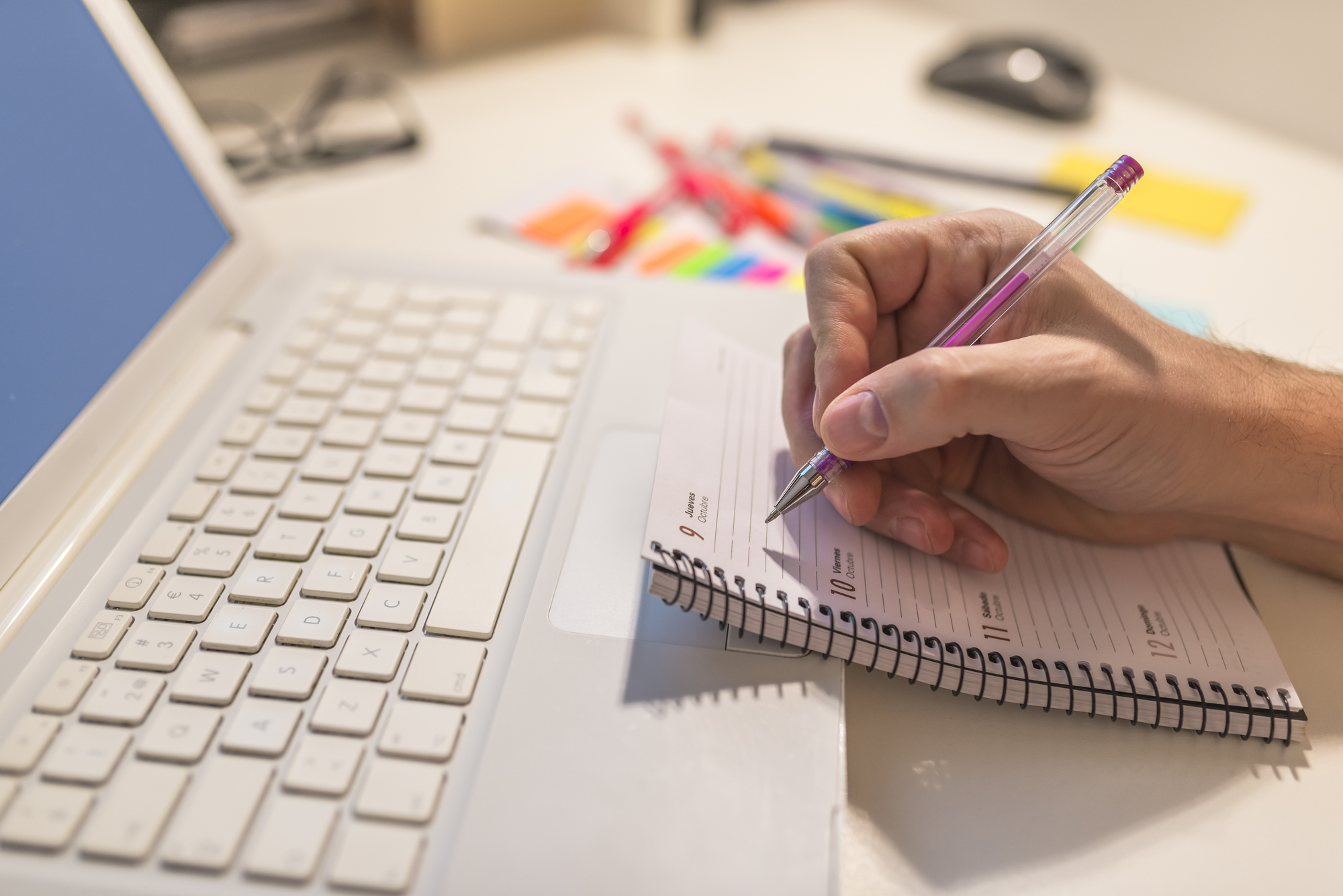 Close-up Of A Businessperson's Hand Writing Schedule In Diary Wi